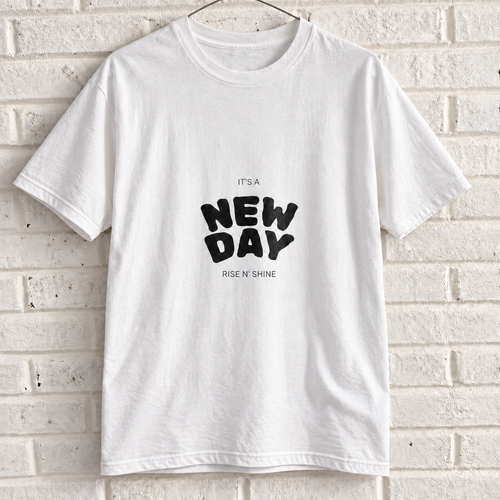 White Comfort Colors graphic tee on a white brick wall with a wire hanger — front view